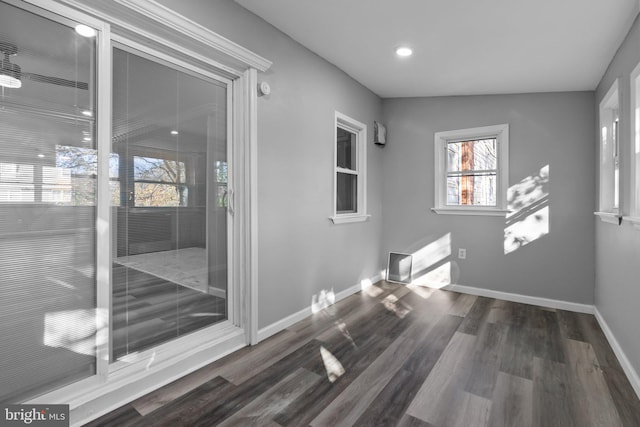 unfurnished room featuring dark wood-type flooring and vaulted ceiling