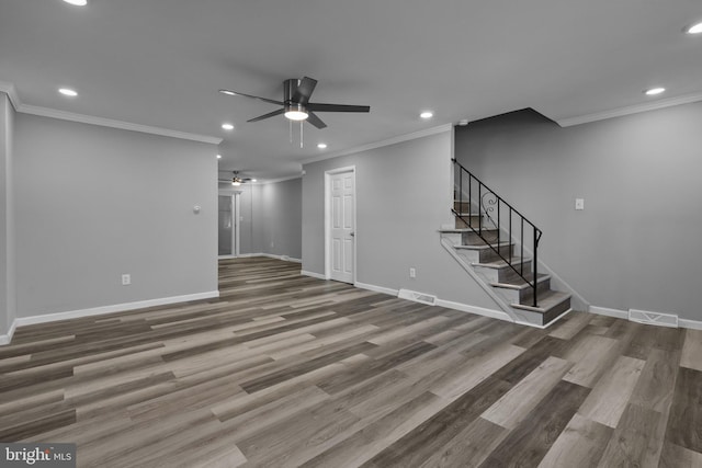 unfurnished living room with hardwood / wood-style flooring, ceiling fan, and ornamental molding