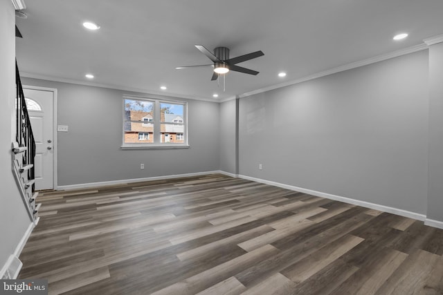 empty room with dark hardwood / wood-style floors, ceiling fan, and crown molding