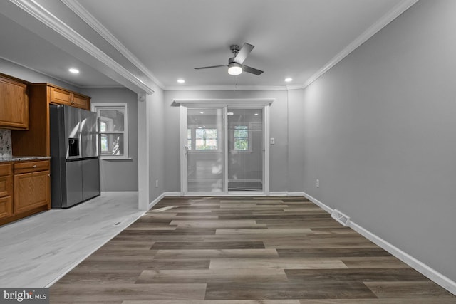 interior space with light hardwood / wood-style floors, ceiling fan, and ornamental molding