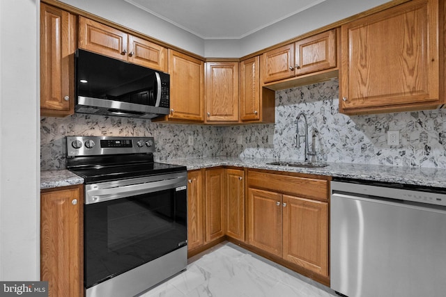 kitchen with sink, light stone countertops, stainless steel appliances, and ornamental molding