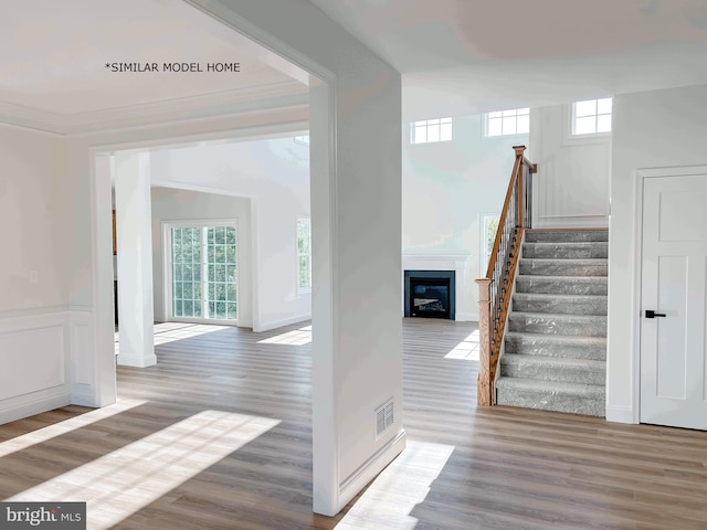 interior space featuring hardwood / wood-style floors and ornamental molding