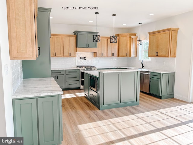 kitchen featuring appliances with stainless steel finishes, light brown cabinetry, light hardwood / wood-style flooring, a kitchen island, and hanging light fixtures