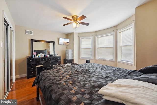 bedroom featuring dark hardwood / wood-style flooring, a closet, and ceiling fan