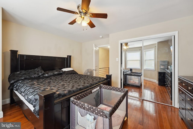 bedroom with ceiling fan, a closet, and dark hardwood / wood-style floors