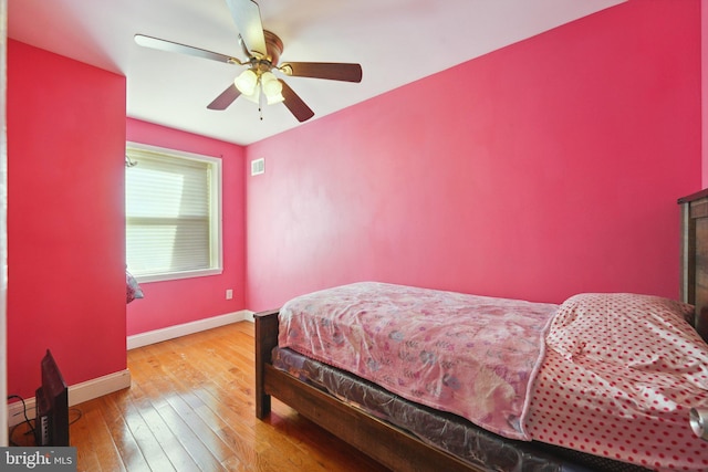 bedroom with ceiling fan and wood-type flooring