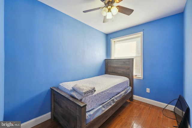 bedroom with dark hardwood / wood-style floors and ceiling fan