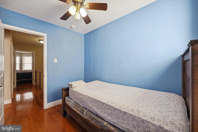 bedroom featuring ceiling fan and dark wood-type flooring