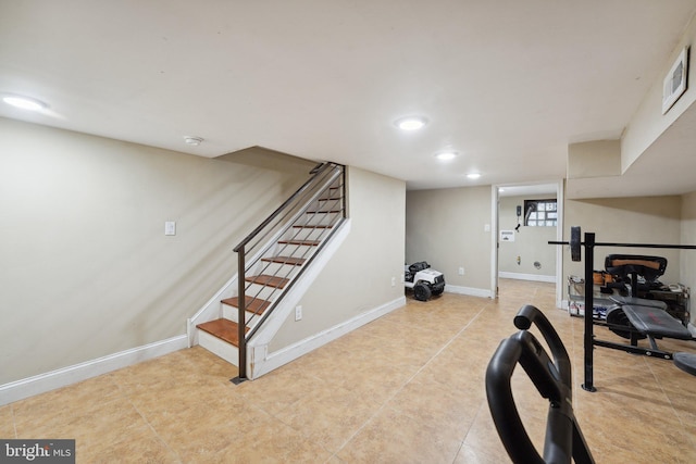 exercise area featuring light tile patterned floors