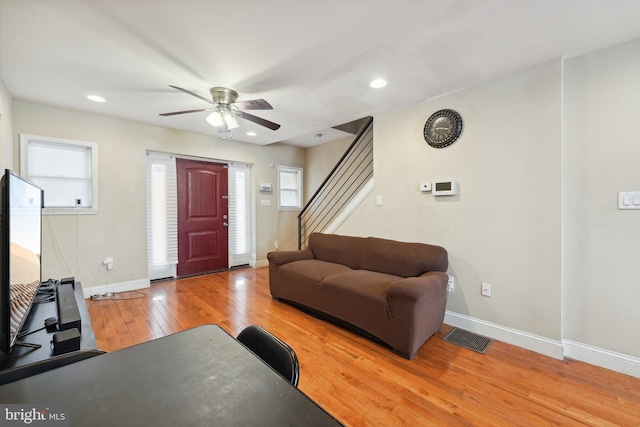 living room with hardwood / wood-style flooring and ceiling fan