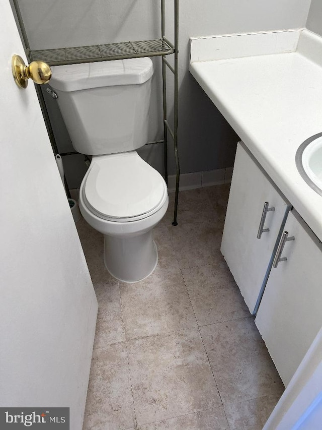 bathroom with tile patterned floors, vanity, and toilet