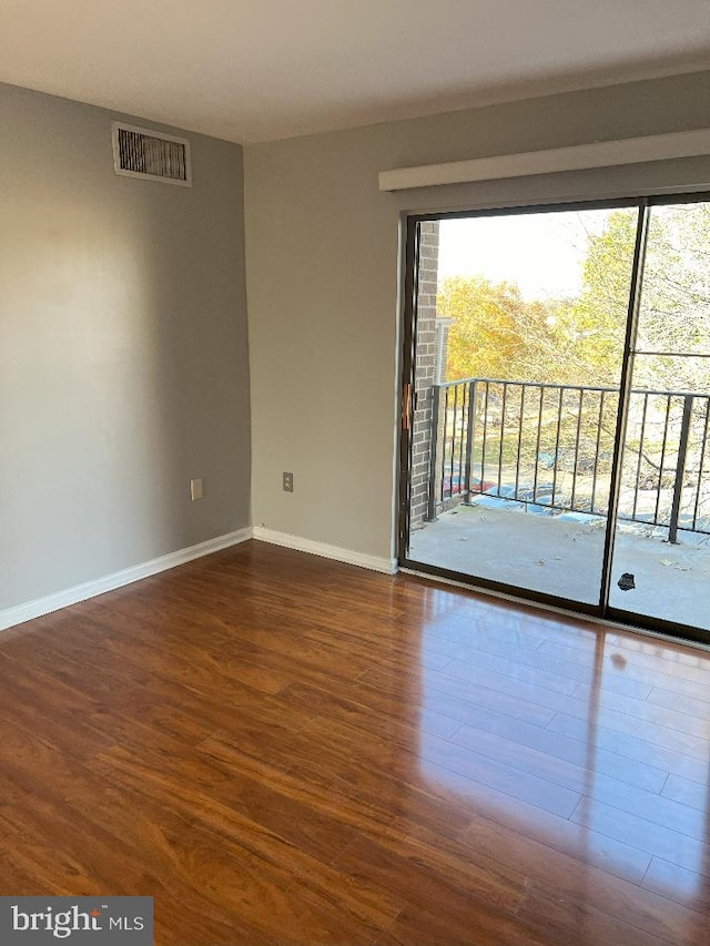 spare room featuring dark hardwood / wood-style floors