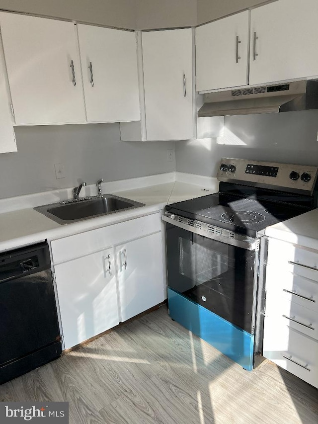 kitchen with stainless steel range with electric cooktop, sink, light wood-type flooring, black dishwasher, and white cabinetry