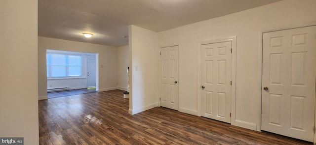 interior space featuring baseboard heating and dark wood-type flooring