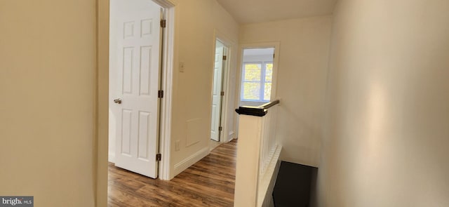 hallway with hardwood / wood-style flooring