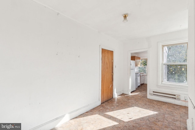 spare room featuring a baseboard heating unit