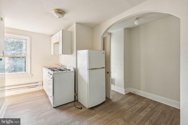 kitchen with sink, a baseboard heating unit, light hardwood / wood-style floors, white appliances, and white cabinets