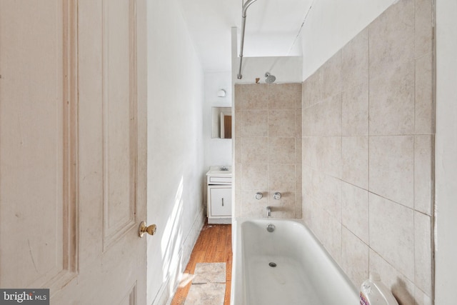 bathroom featuring a tub to relax in and hardwood / wood-style flooring