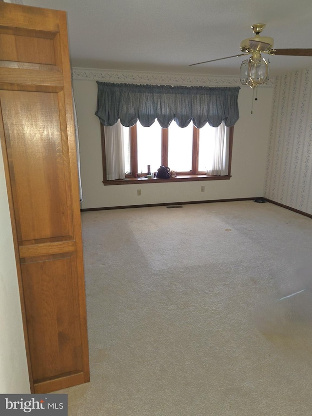 unfurnished room featuring light carpet