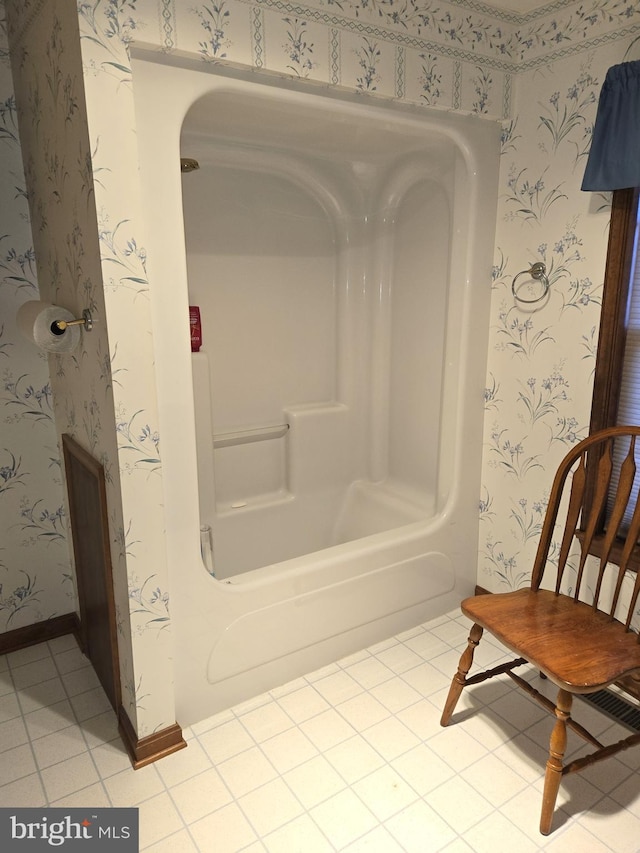 bathroom featuring tile patterned flooring and a bath