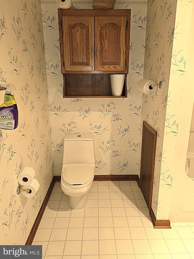 bathroom featuring toilet and tile patterned flooring