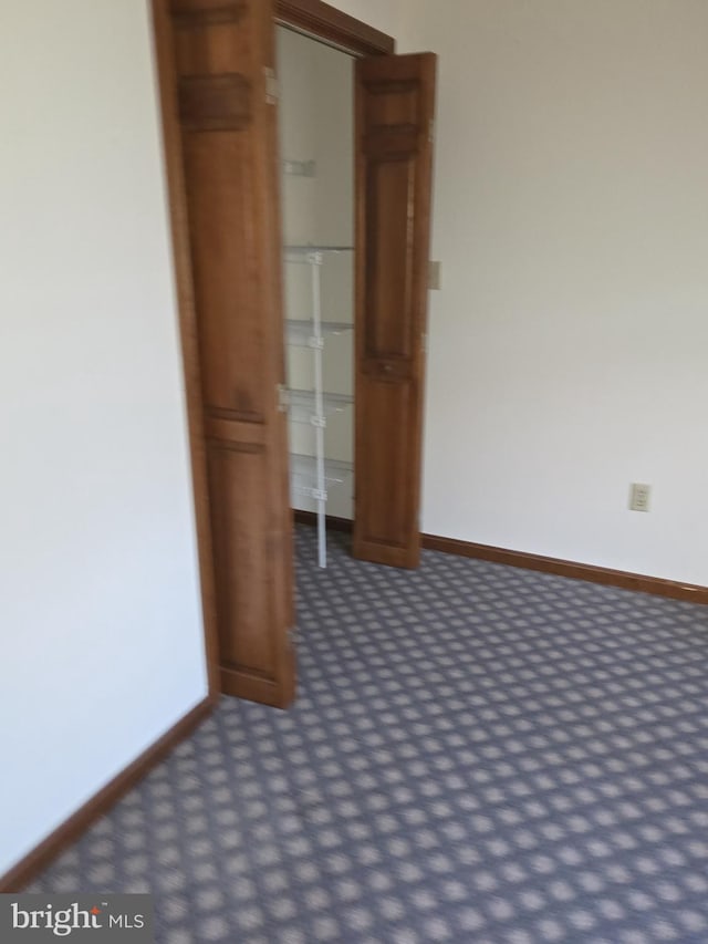 unfurnished room featuring carpet floors