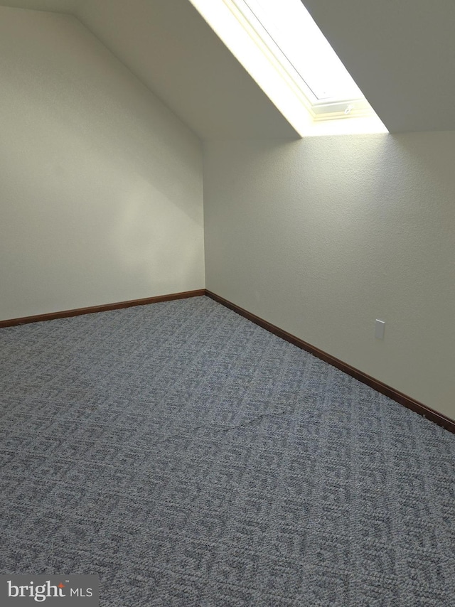 bonus room with carpet floors and lofted ceiling with skylight