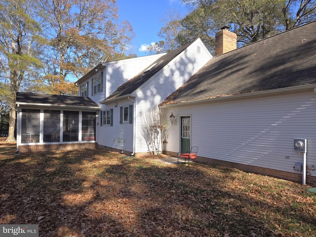 rear view of house with a sunroom