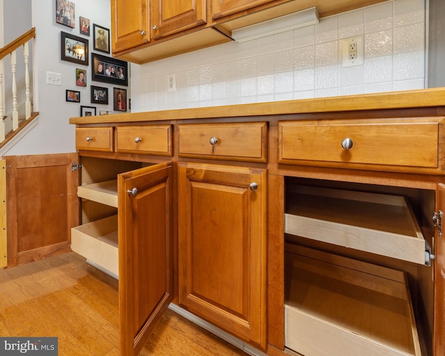 kitchen featuring decorative backsplash and light hardwood / wood-style floors