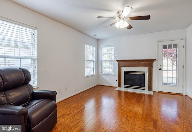 unfurnished living room with hardwood / wood-style flooring and ceiling fan