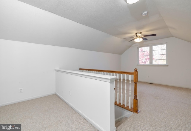 bonus room with a textured ceiling, light carpet, ceiling fan, and lofted ceiling