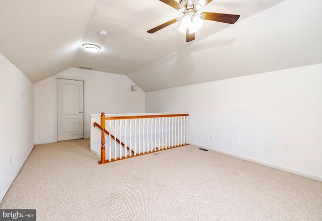 additional living space with light carpet, ceiling fan, and lofted ceiling