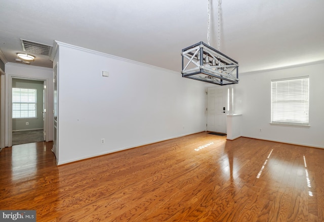 unfurnished dining area featuring hardwood / wood-style flooring and ornamental molding