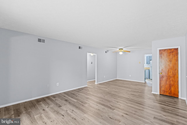 empty room featuring ceiling fan and light hardwood / wood-style floors