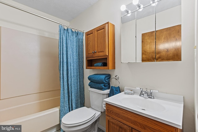 full bathroom featuring vanity, toilet, a textured ceiling, and shower / tub combo