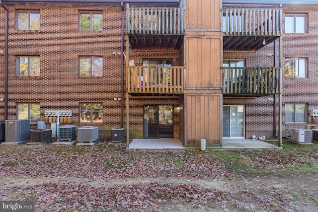 rear view of house with cooling unit and a patio area