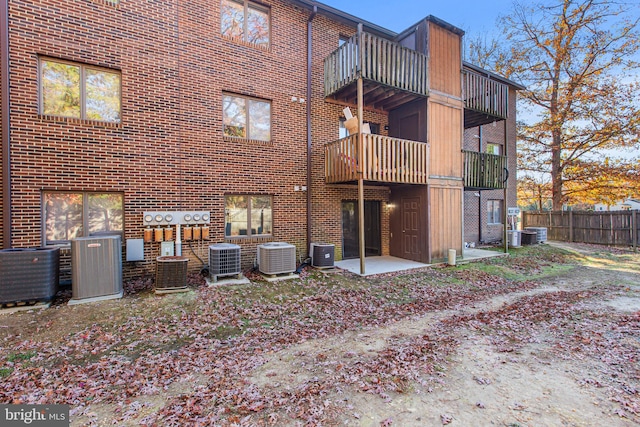 rear view of house featuring central AC