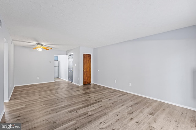 unfurnished living room featuring a textured ceiling, light hardwood / wood-style floors, and ceiling fan