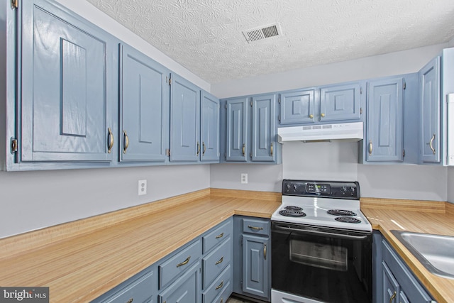 kitchen with wood counters, white electric range, sink, blue cabinets, and a textured ceiling