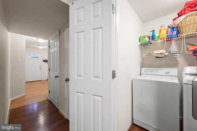 laundry area with dark hardwood / wood-style floors and separate washer and dryer