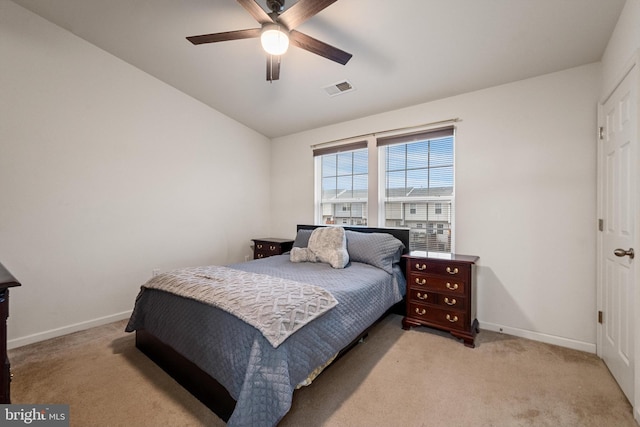 bedroom with ceiling fan, light colored carpet, and lofted ceiling