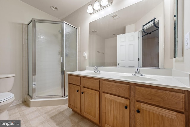 bathroom featuring an enclosed shower, vanity, and toilet