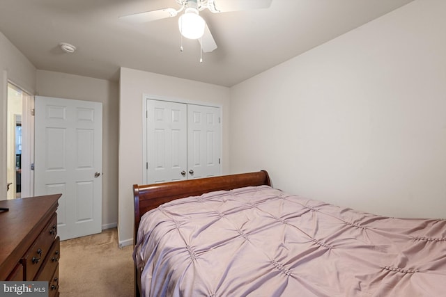 carpeted bedroom featuring a closet and ceiling fan