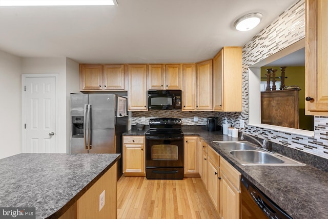 kitchen featuring sink, tasteful backsplash, light hardwood / wood-style flooring, light brown cabinetry, and black appliances