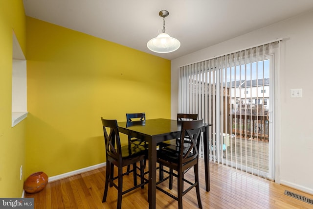 dining area with hardwood / wood-style flooring