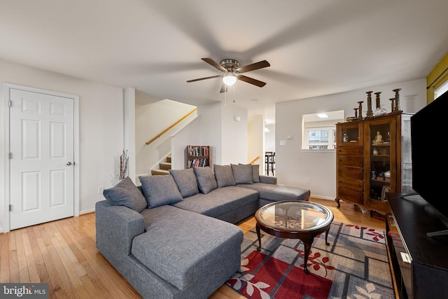 living room with hardwood / wood-style floors and ceiling fan