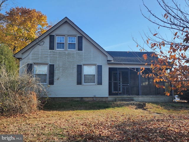 back of property featuring a yard and a sunroom