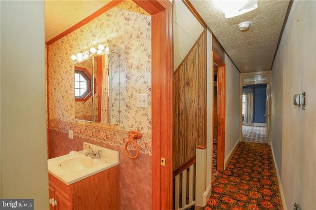 hallway featuring crown molding and sink