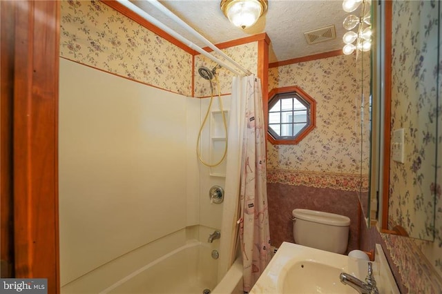 full bathroom with shower / bath combination with curtain, toilet, and sink