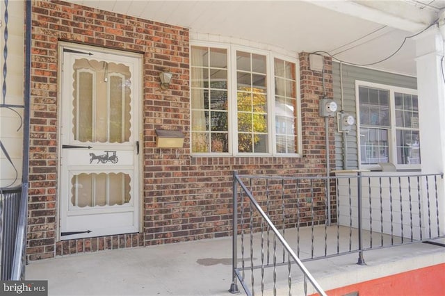 view of exterior entry with covered porch